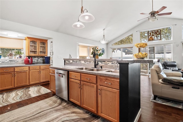 kitchen with sink, hanging light fixtures, dark hardwood / wood-style flooring, stainless steel dishwasher, and backsplash