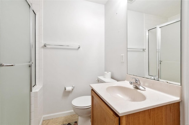 bathroom with tile patterned flooring, vanity, toilet, and a shower with shower door