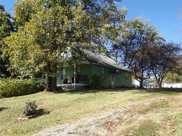 view of side of property with a lawn