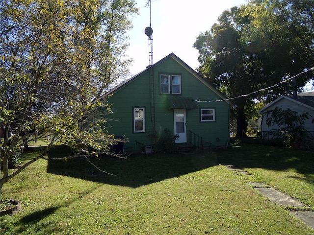 rear view of property with a yard