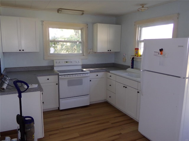 kitchen with white appliances, dark wood-type flooring, and white cabinets