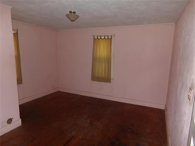 spare room with dark wood-type flooring