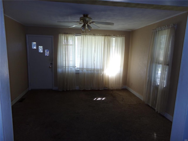 foyer entrance featuring carpet and ceiling fan