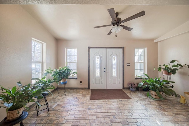 foyer entrance with ceiling fan