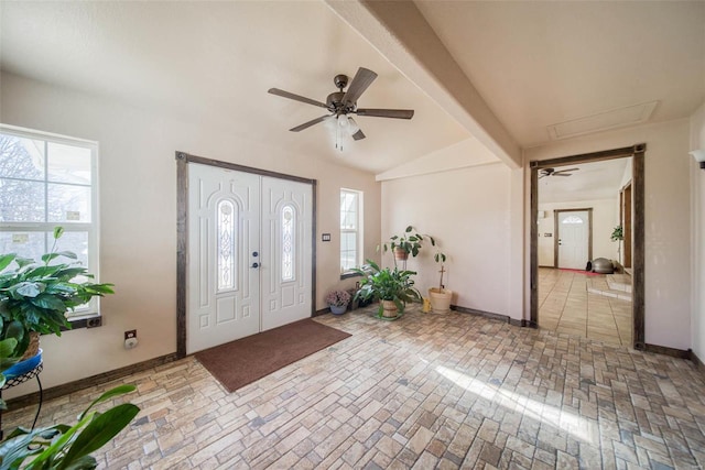 foyer with ceiling fan and vaulted ceiling