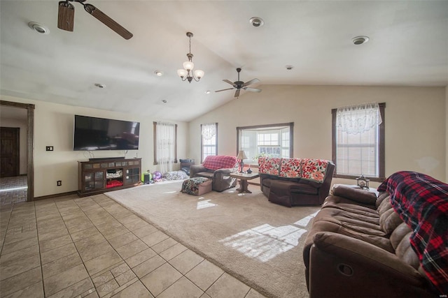 living room featuring ceiling fan with notable chandelier, light tile patterned floors, and vaulted ceiling