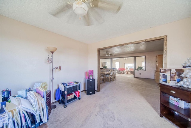 misc room featuring ceiling fan, carpet, and a textured ceiling