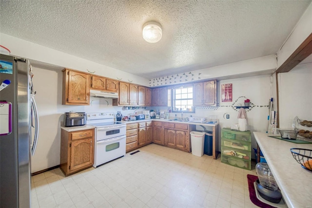 kitchen featuring white range with electric cooktop, a textured ceiling, and stainless steel refrigerator