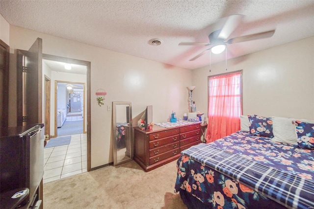 carpeted bedroom with a textured ceiling and ceiling fan