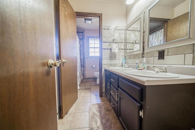 bathroom with decorative backsplash, tile patterned flooring, vanity, and toilet