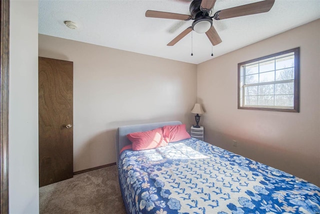 bedroom featuring carpet flooring, ceiling fan, and a textured ceiling