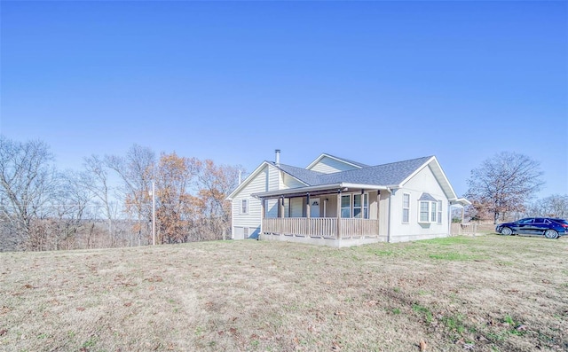 view of front facade with covered porch and a front yard