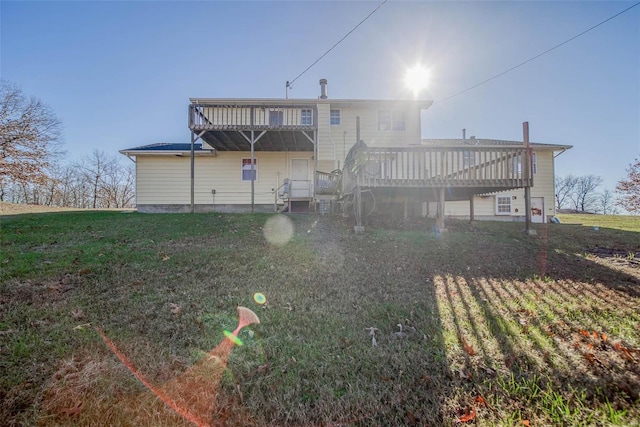 back of house featuring a yard and a deck