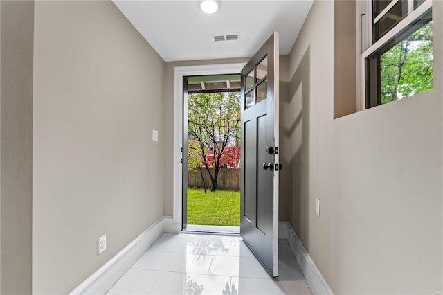 doorway to outside featuring light tile patterned floors