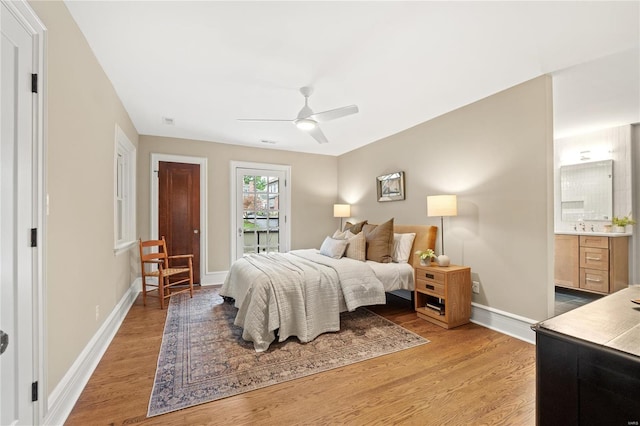 bedroom with connected bathroom, light hardwood / wood-style floors, and ceiling fan