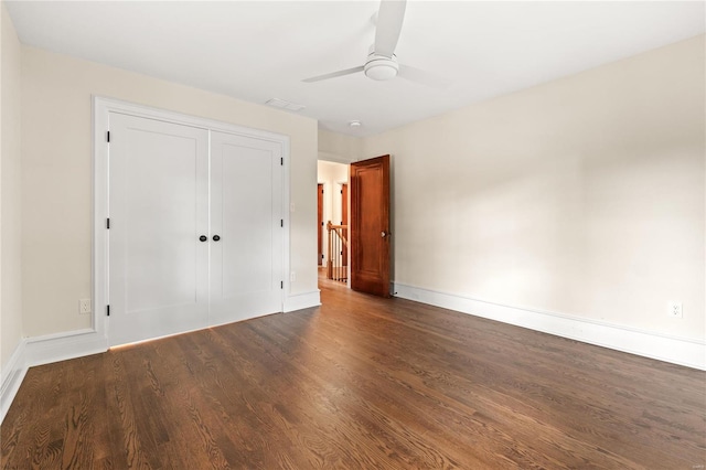 unfurnished bedroom featuring a closet, ceiling fan, and dark wood-type flooring