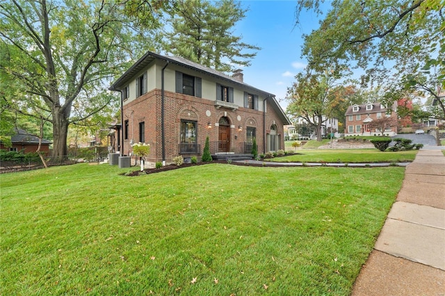 view of front facade with cooling unit and a front lawn