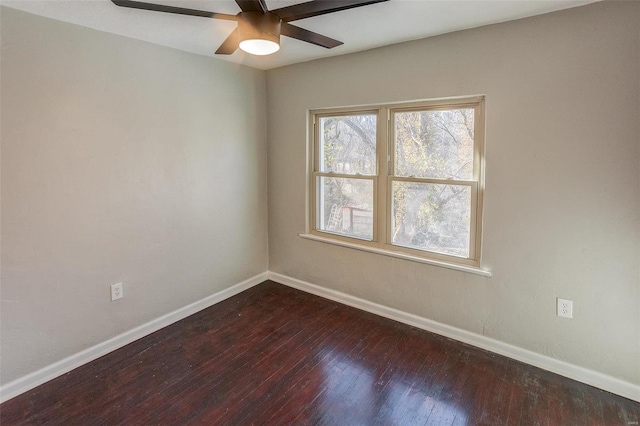 empty room with ceiling fan and dark hardwood / wood-style floors