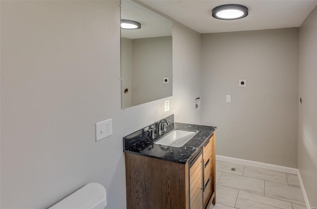 bathroom featuring vanity and toilet