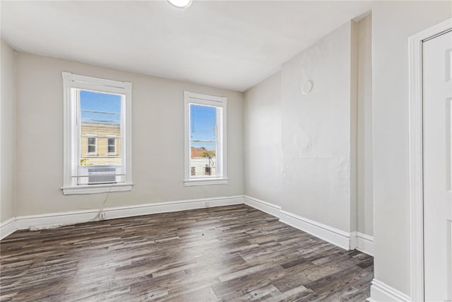 unfurnished room with dark wood-type flooring and cooling unit