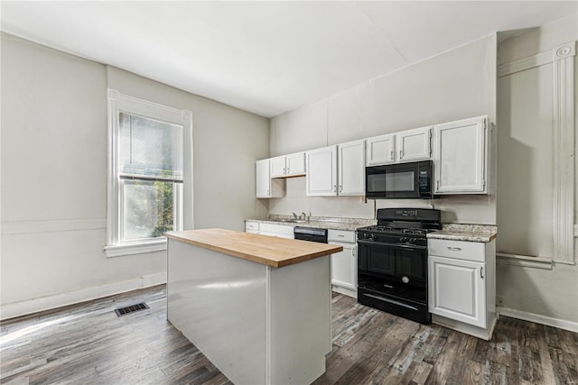 kitchen featuring black appliances, white cabinets, dark hardwood / wood-style floors, and wood counters