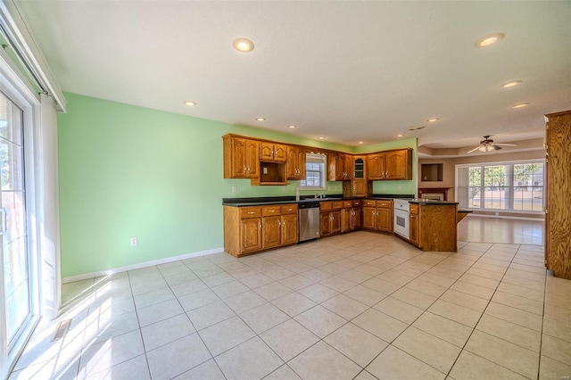 kitchen with stainless steel dishwasher, light tile patterned flooring, kitchen peninsula, and ceiling fan