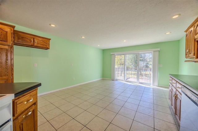 kitchen with dishwasher, a textured ceiling, and light tile patterned floors