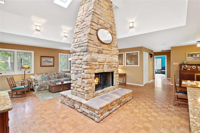 living room featuring light parquet flooring, a skylight, and a fireplace