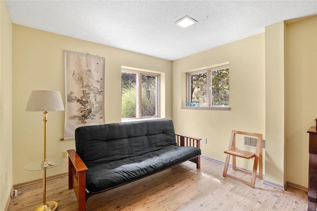 sitting room featuring a textured ceiling and light wood-type flooring