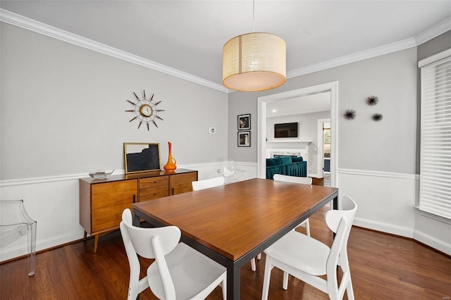 dining area featuring dark hardwood / wood-style flooring and crown molding