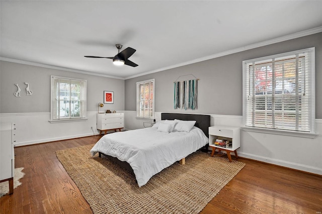 bedroom featuring ceiling fan, dark hardwood / wood-style flooring, and crown molding