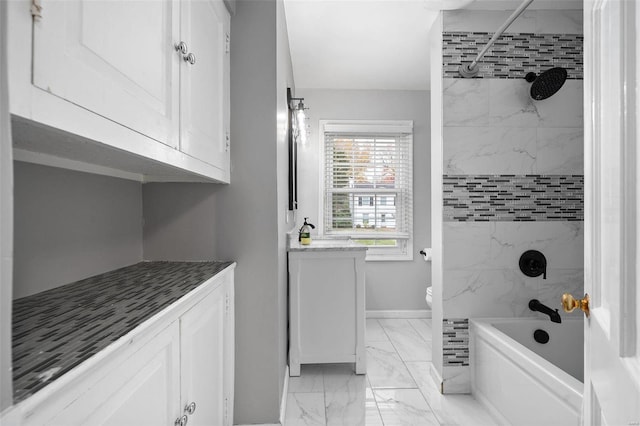 full bathroom with toilet, vanity, and tiled shower / bath combo