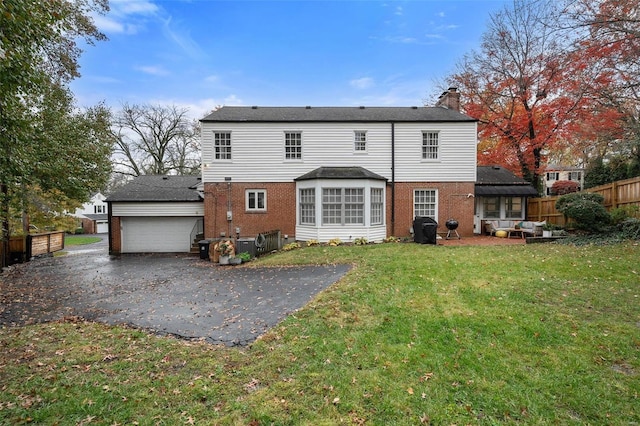 back of property with a patio area and a lawn