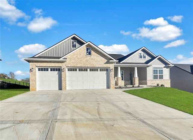 craftsman-style home featuring a front yard and a garage