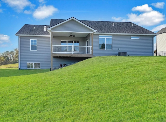 back of house with a yard, ceiling fan, and cooling unit