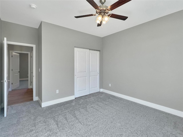 unfurnished bedroom with a closet, carpet flooring, and ceiling fan