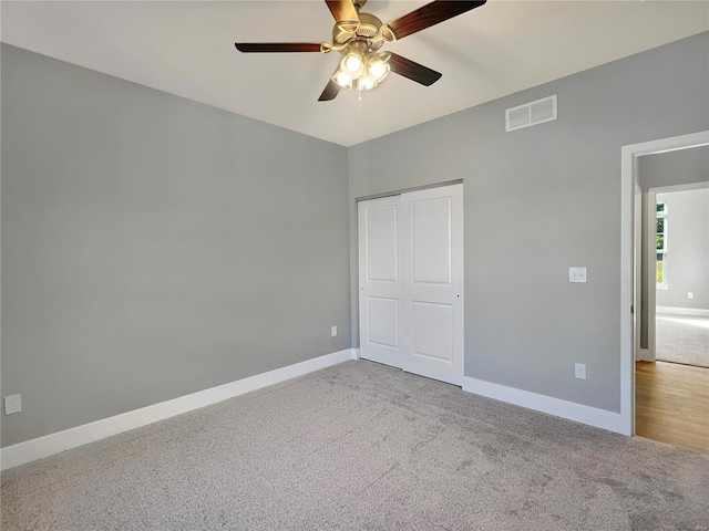 unfurnished bedroom with carpet flooring, a closet, and ceiling fan