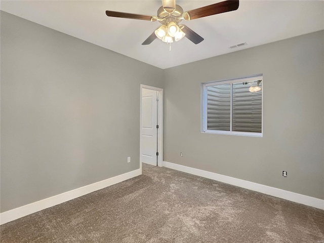 carpeted spare room with ceiling fan