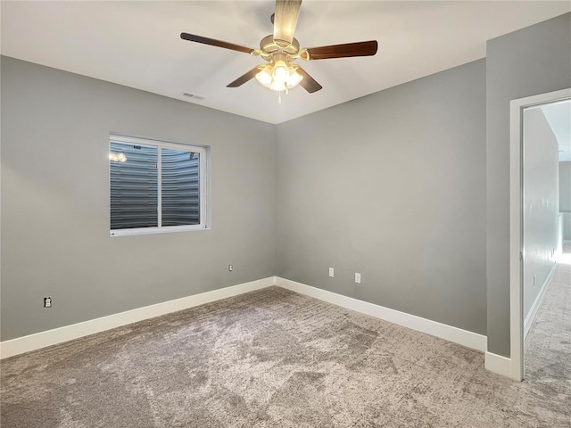 carpeted spare room with ceiling fan