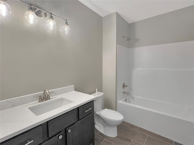 full bathroom with toilet, vanity, tile patterned floors, and washtub / shower combination