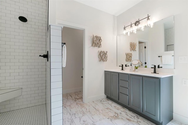 bathroom featuring vanity and tiled shower