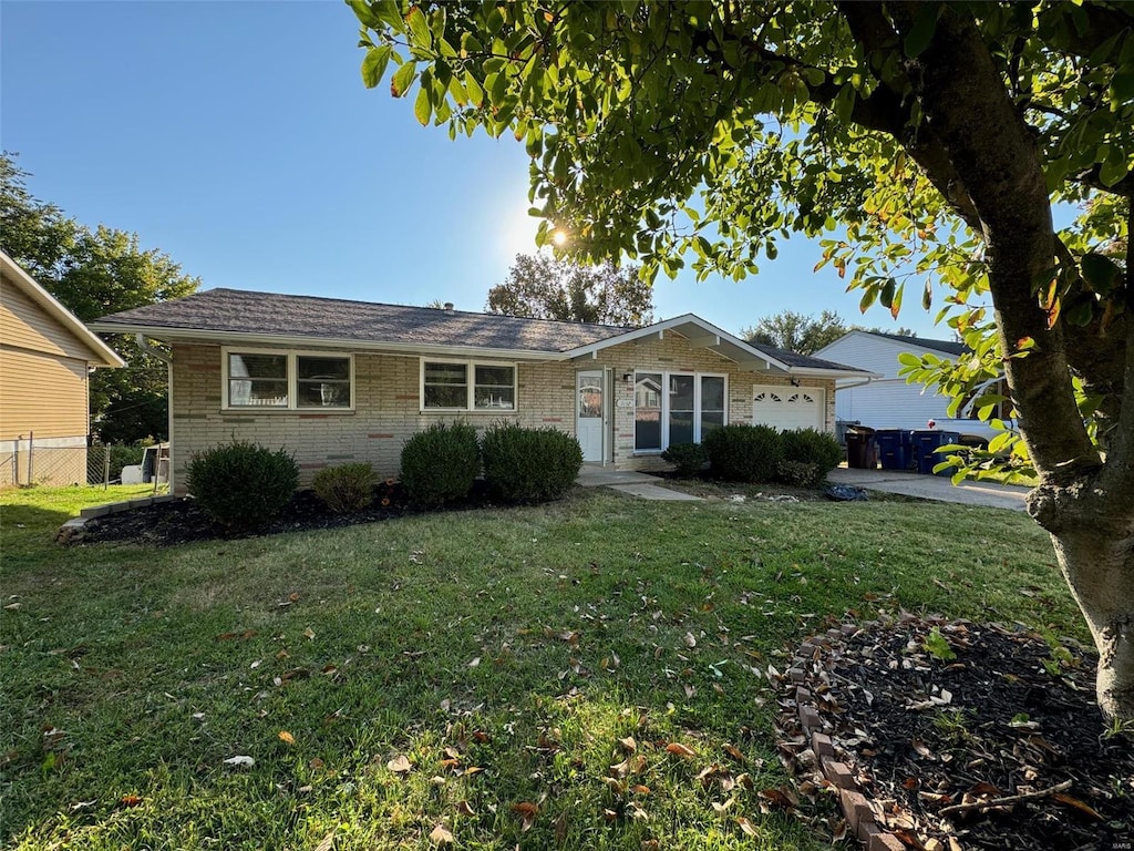 ranch-style house with a front yard and a garage