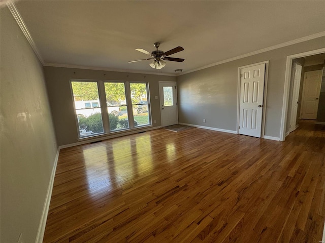 empty room with ceiling fan, crown molding, and hardwood / wood-style floors