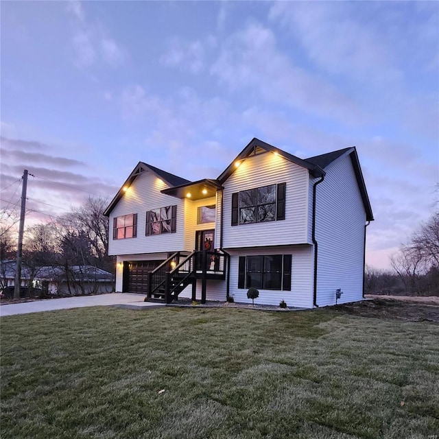 split foyer home featuring a yard and a garage