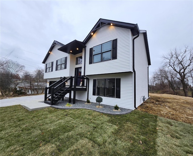 view of front of property with a patio area and a front lawn