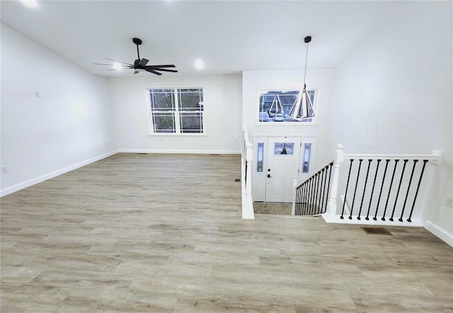 entrance foyer with ceiling fan and light hardwood / wood-style flooring