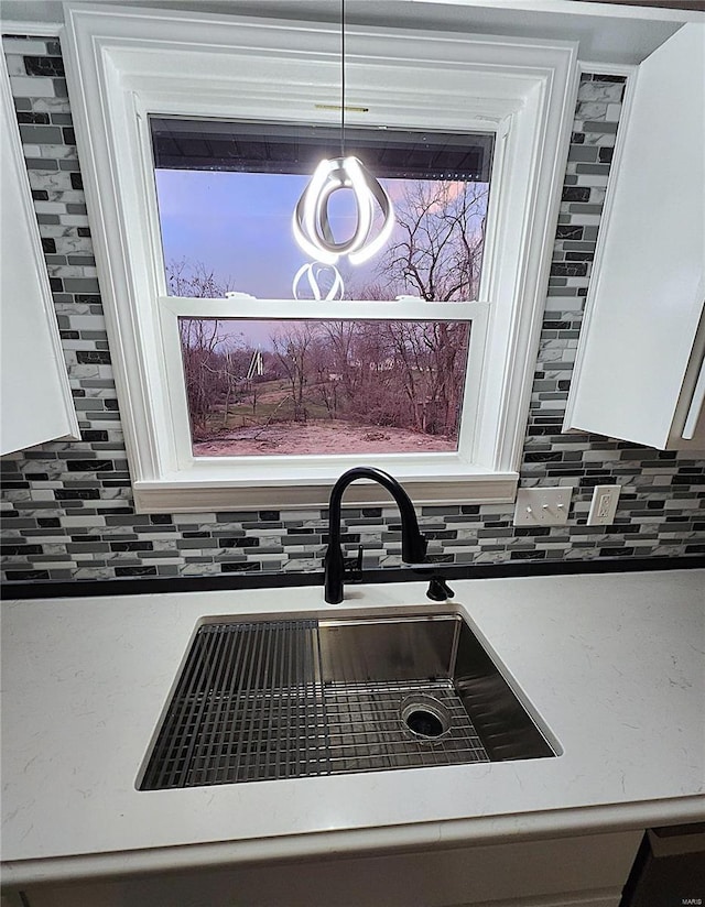 room details with sink, white cabinetry, and tasteful backsplash