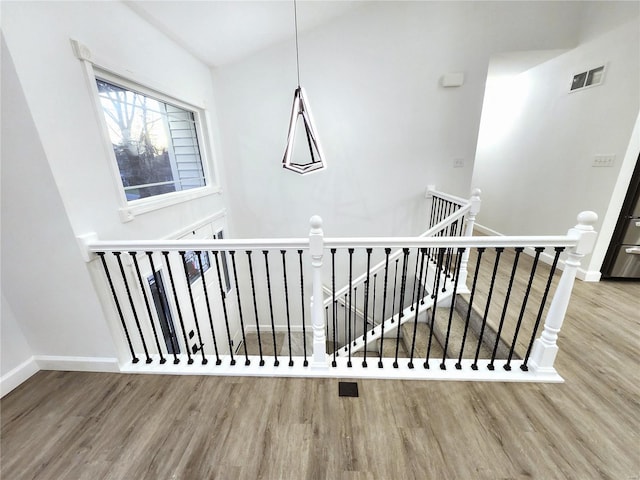 stairway featuring wood-type flooring