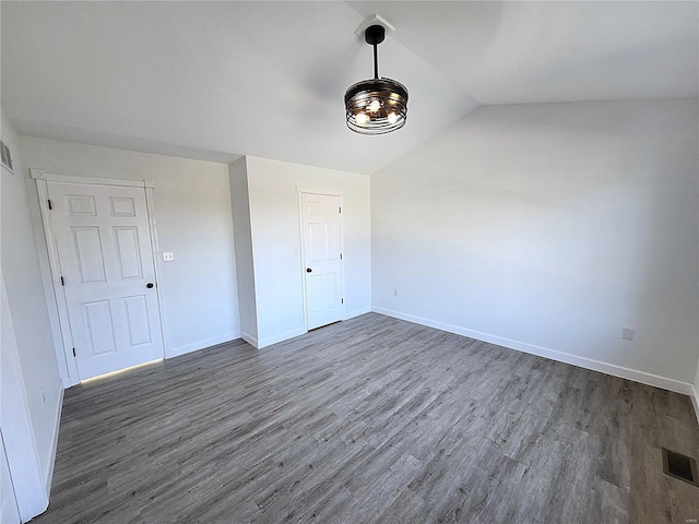 unfurnished room with lofted ceiling and dark hardwood / wood-style flooring