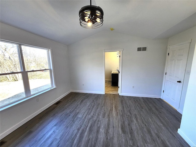 unfurnished bedroom featuring lofted ceiling and dark wood-type flooring